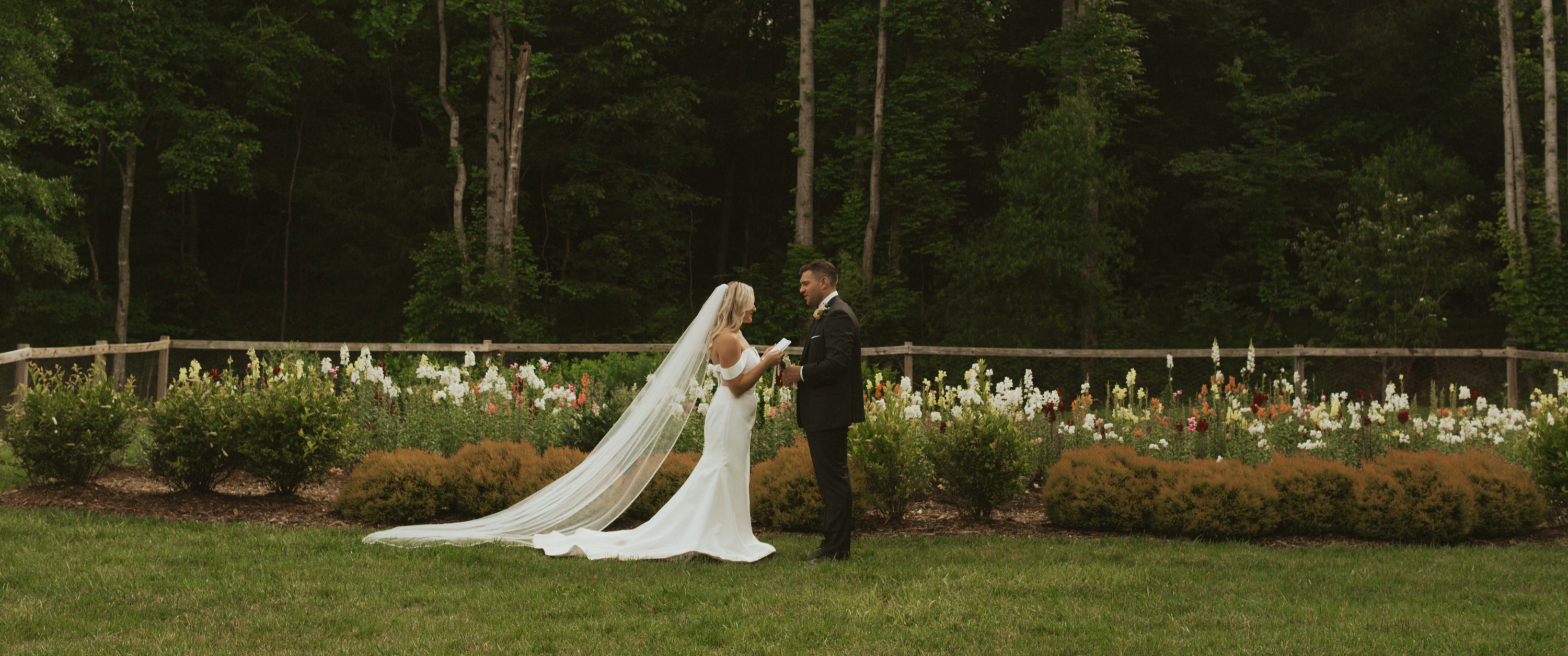 Couple at flower garden fence with blooms